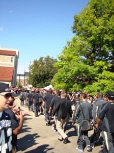 Players and coaches take "The Walk" to Folsom Field
